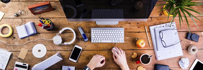 Business person working at office desk wearing smart watch