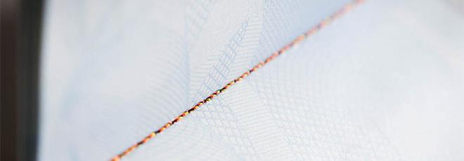 Sewing threads to secure paper against counterfeiting